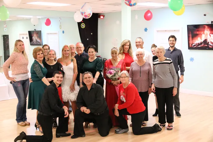 The full Dance Passion group posed together on the studio floor