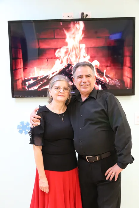Lourdes and Ivan posed arm in arm in front of the fireplace screen