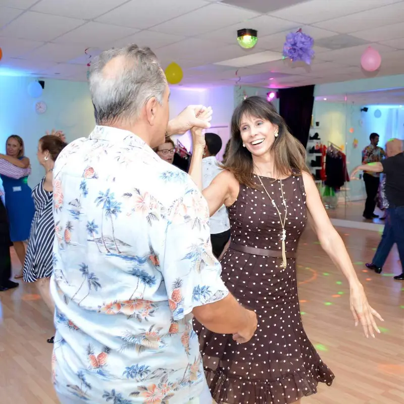 A smiling couple dancing together at a Dance Passion party in St. Petersburg