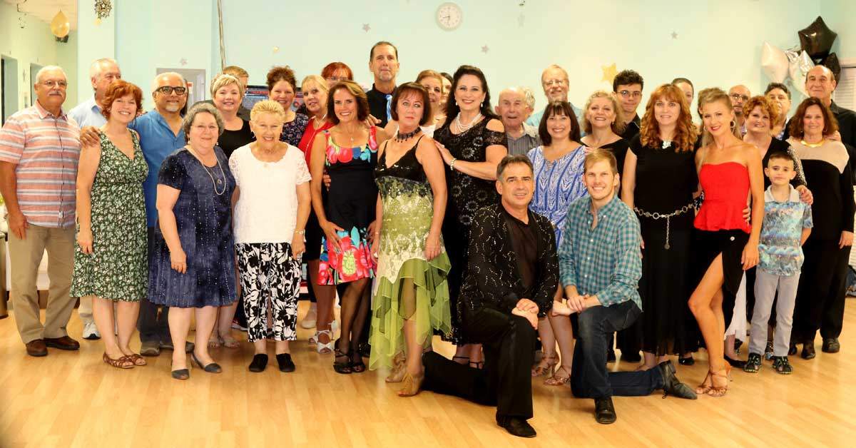 A large group of Dance Passion students and teachers posing together in the studio