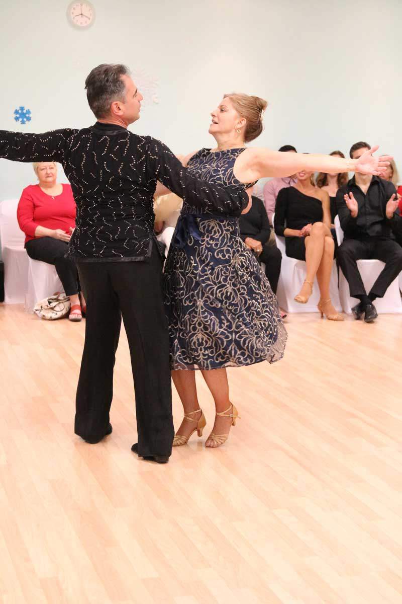 Lourdes and Ivan dancing in front of an audience at a studio showcase