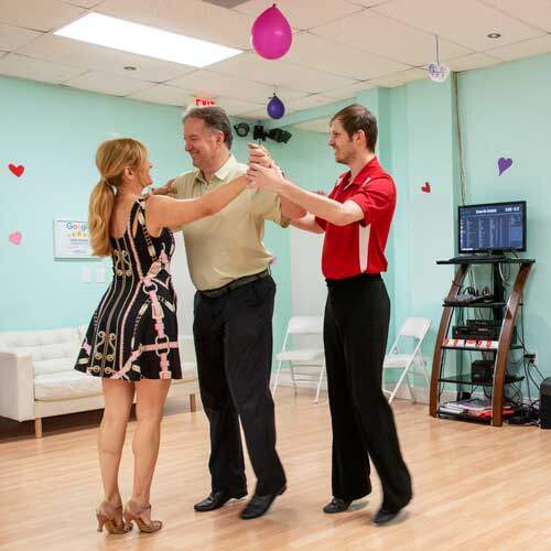 Couple trying a free lesson in ballroom dancing